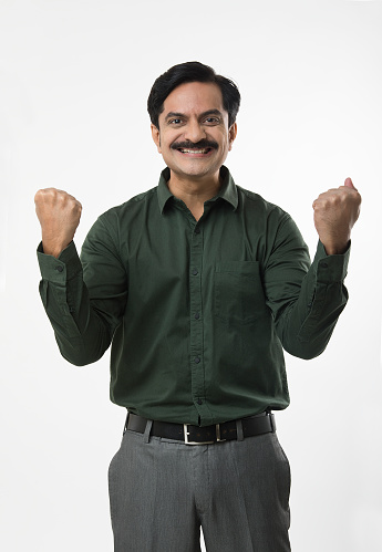 Portrait of smiling confident Indian male entrepreneurs in business wear standing against isolated white background