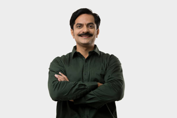 istock Confident businessman with arms crossed on white background 1446032712
