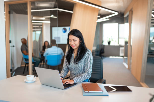 istock Young Hispanic woman working on laptop at her office table 1446033499