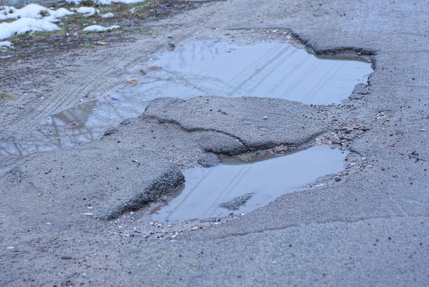 istock big pothole with dirty water and a puddle 1446034092