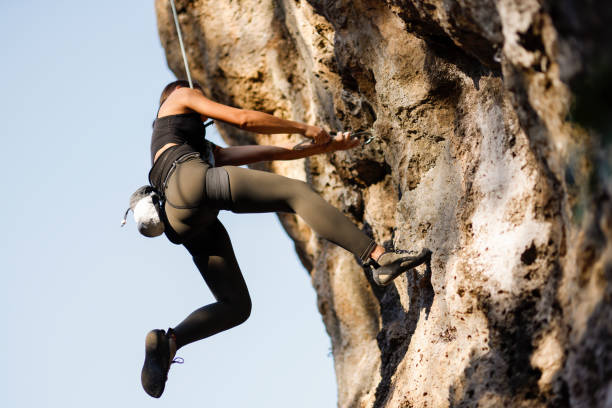 istock Woman challenging rock climbing on limestone wall 1446034119