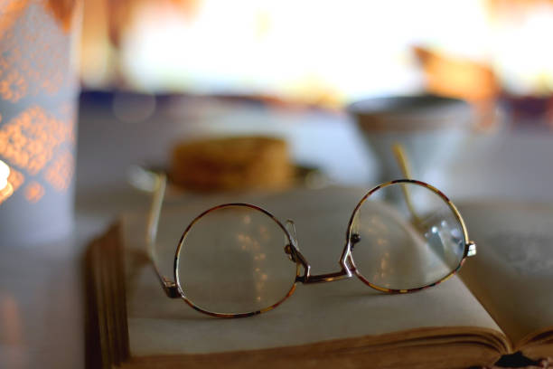 istock Tea, Cookies, Candle, Book, Glasses and Fireplace 1446035086