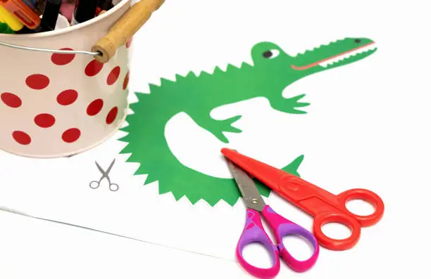 Child development concept. Peper cut out picture for kids with scissors.