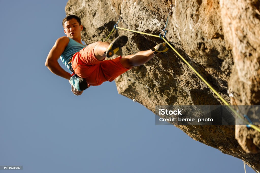 man challenging rock climbing on limestone wall Man enjoys challenging rock climbing on limestone wall Challenge Stock Photo