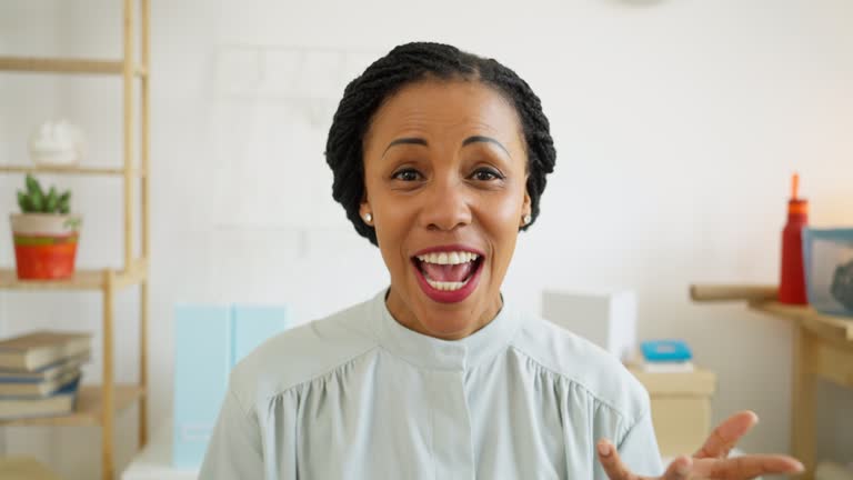 Portrait of smiling African-American businesswoman while having a video conference at her office