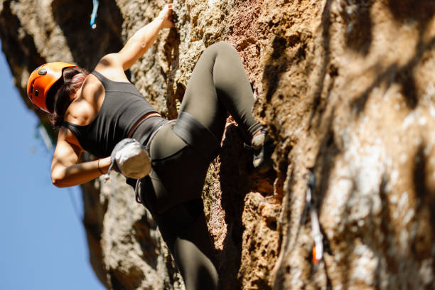 istock Woman challenging rock climbing on limestone wall 1446036084