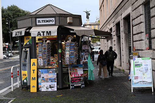 Rome, Italy, november 22, 2022 : Newsstand and ATM cash machine on a street in Rome