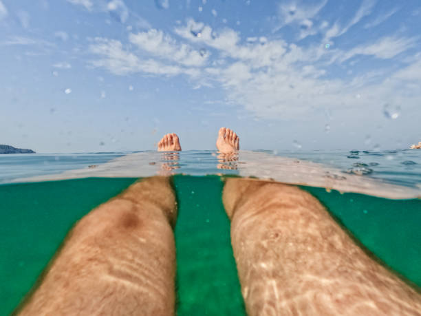 istock Young Man Swimming In The Sea 1446040548