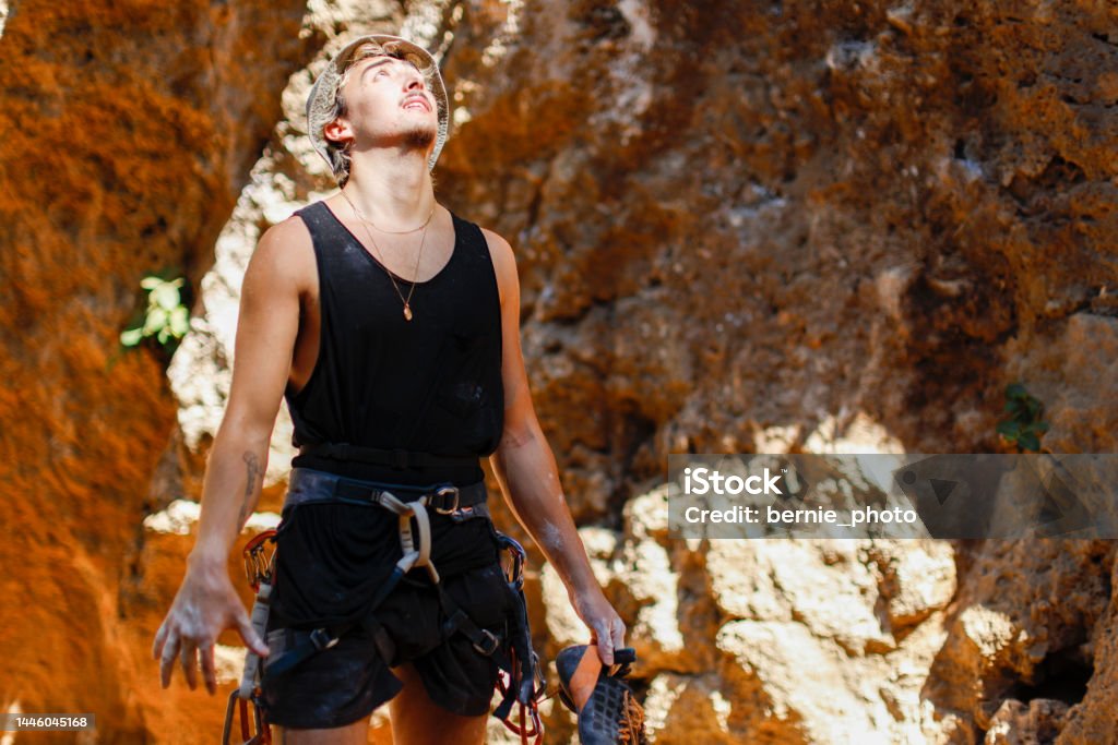 Rock climber stretching fingers to release muscle stress Rock climbers stretch their fingers to release muscle pressure and reduce lactic acid accumulation Achievement Stock Photo