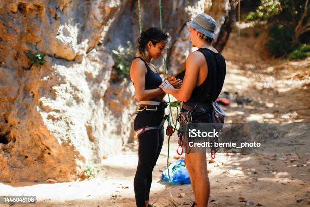 Team Members Getting Ready For Rock Climbing At Lime Climbing Site Stock Photo - Download Image Now
