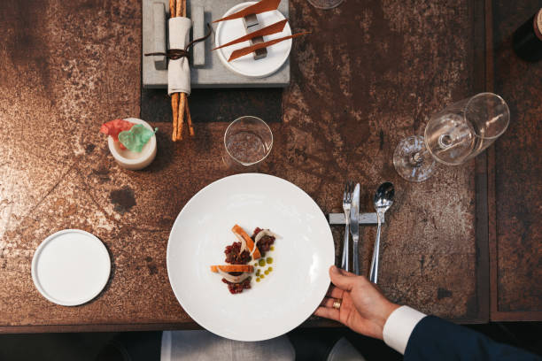 istock Waiter serves a steak tartare to a table in a restaurant 1446046899