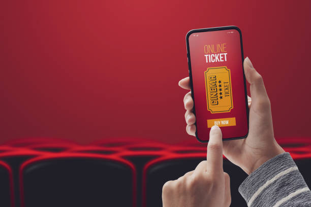User buying movie tickets online stock photo