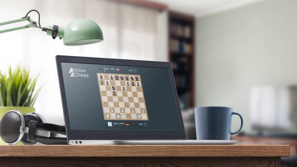 User playing chess online on the laptop Online chess game on the laptop at home, online strategy games concept computer chess stock pictures, royalty-free photos & images