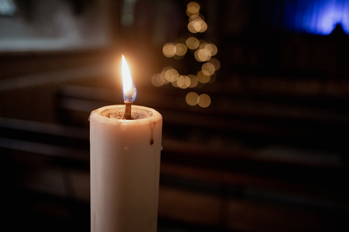 Candles gently flickering in the peace and tranquility of a quiet church