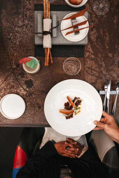 istock Waiter serves a steak tartare to a table in a restaurant 1446047988