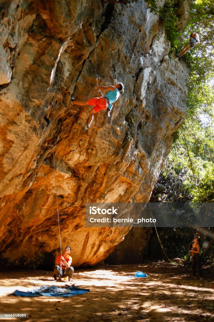 Teamwork enjoys climbing challenges Teamwork outdoors and enjoy rock climbing challenges Achievement Stock Photo