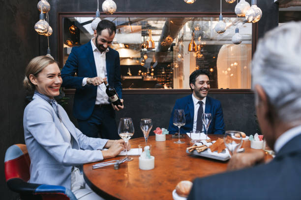 istock Waiter serving high end red wine to a business table 1446049822
