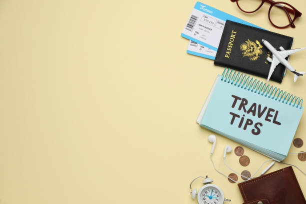 istock Notebook with phrase Travel Tips and tourist items on yellow background, flat lay. Space for text 1446049942