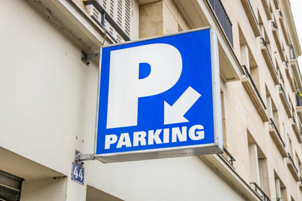 car park sign with a white arrow and a big p letter in paris - parking lot imagens e fotografias de stock