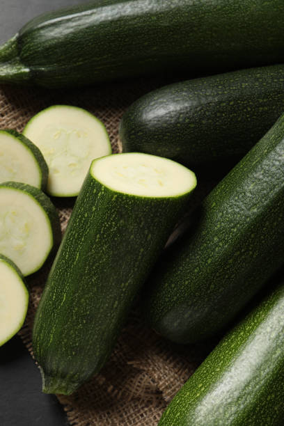istock Whole and cut ripe zucchinis on table, flat lay 1446050564