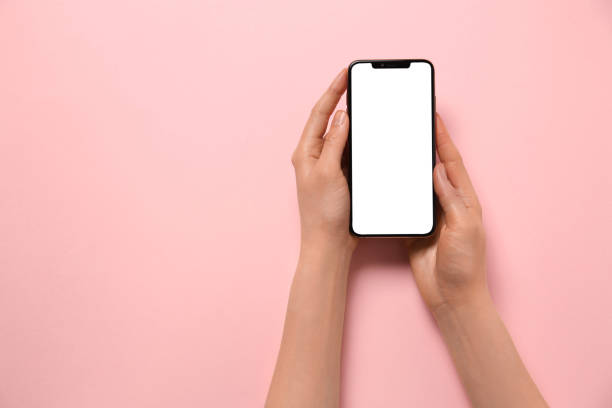 istock Woman with smartphone on pink background, top view. Space for text 1446050868
