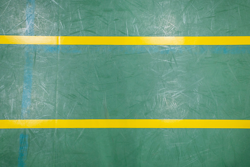 A medium shot, looking down to the floor of an indoor sports court.