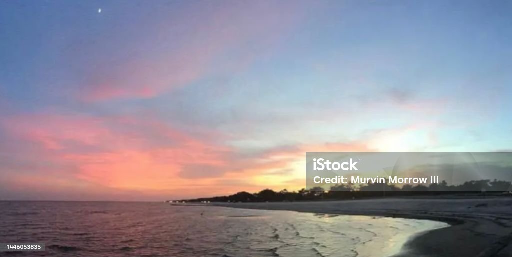 Sunset at the Gulf Coast Sunset At the Beach, Twilight as Sun Falls Over Horizon Coastline Stock Photo