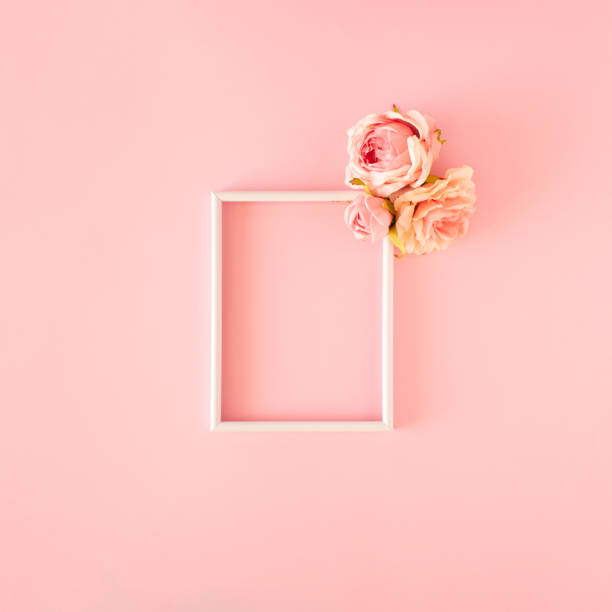istock Picture frame with roses on pink background.  Valentine's day concept. 1446053995