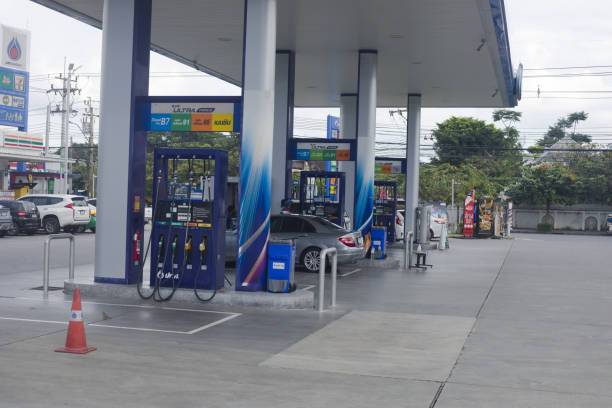 Ptt gasoline station in Bangkok Ladprao. A few customers are getting fuel. Some staffs are at work. Fuel station is at Wanghin Road