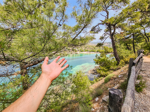 Beautiful view of the coastline in Thasos, Greece. Young man's POV. Gesturing with his arms.