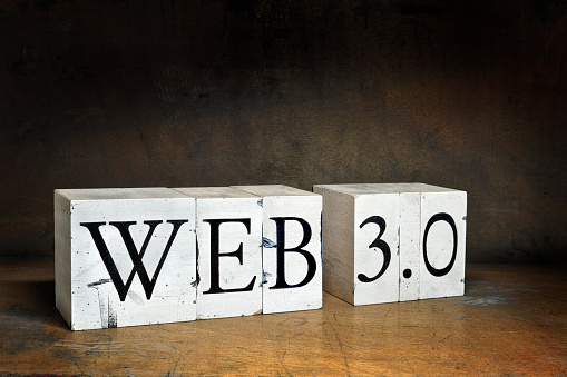 WEB 3.0, word with serifs on old and dirty blocks on old wood in dark surroundings. Different words in the same style can be found below: