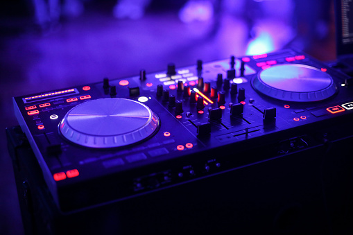 Clubbing and nightlife - turntable and sound mixer in a nightclub.