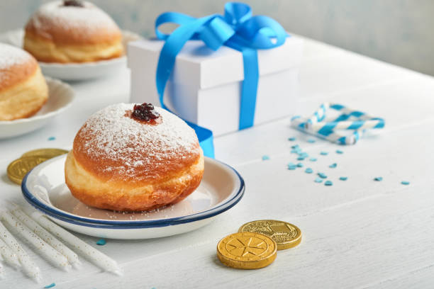 Happy Hanukkah. Hanukkah sweet doughnuts, gift boxes, white candles and chocolate coins on white wooden background. Image and concept of jewish holiday Hanukkah. Top view. Happy Hanukkah. Hanukkah sweet doughnuts, gift boxes, white candles and chocolate coins on white wooden background. Image and concept of jewish holiday Hanukkah. Top view. orthodox judaism photos stock pictures, royalty-free photos & images