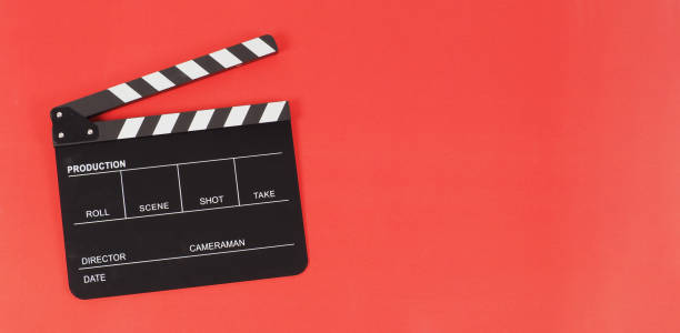 istock Black clapper board or movie slate on red background. 1446059997