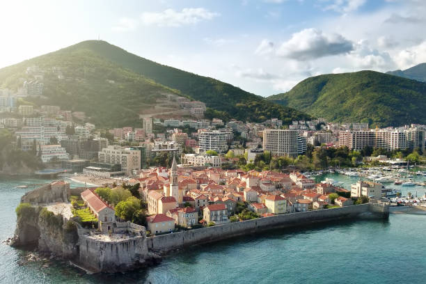 Panoramic sunset aerial drone view of the ancient city of Budva, Montenegro. Old medieval town. stock photo