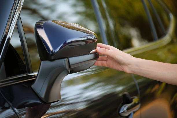 istock Driver hands adjusting side view mirror of a car 1446061525