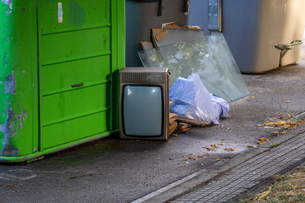 istock Garbage container with bags, glass and an old television on the floor 1446064432