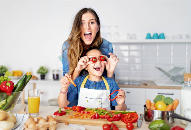 istock Mother and daughter cooking together in a kitchen 1446065066