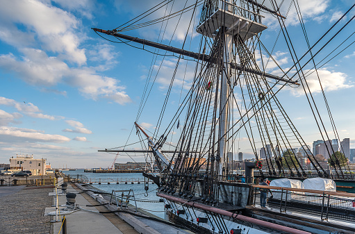 Boston, MA, USA - Nov 23, 2022: View of USS Constitution, a heavy frigate of the United States Navy moored close to The Freedom Trail in Boston, Massachusetts. She is the world's oldest ship still afloat. Constitution is most noted for her actions during the War of 1812 against the United Kingdom when she captured numerous merchant ships and defeated five smaller British warships.