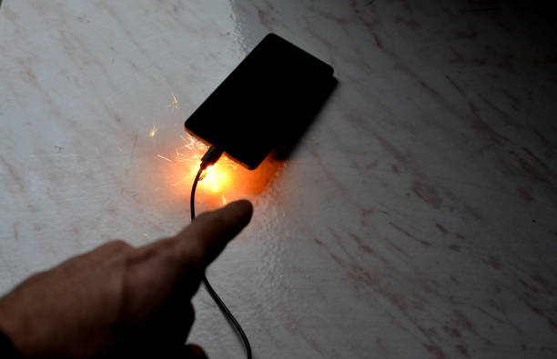 istock Cell phone battery failure. A smartphone can quickly catch fire and set fire to a house, apartment, or car. there is a risk of burns to the device user. flames surround the entire tablet laptop comp 1446066869