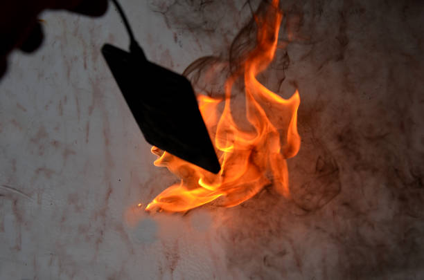 connected to charger in socket. never charge battery overnight, there is risk of battery catching fire, unattended transformer. skin burns when saving property, disconnecting from electric source, stick, port, burnout, dangerous, device, electric, smartphone, sparkle, explosion, flames, home, lithium battery,  fire, extinguisher, total, malfunction, damaged, kitchen, living room, table top, desk, school, children