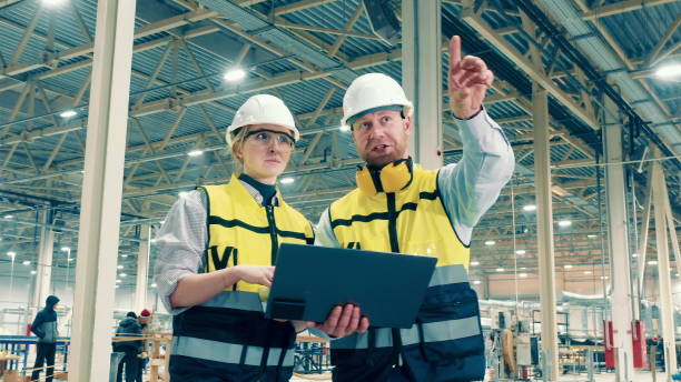 istock Two factory specialists are smiling while making plans 1446067088