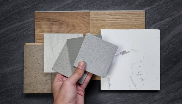 istock interior designer picking material samples. mood and tone board including wooden vinyl flooring tiles, white marble quartzs, engineering flooring tiles, stone tile, grainy artificial stones. 1446067661