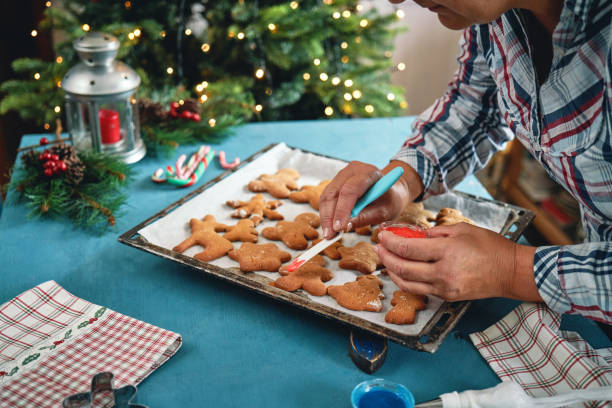 istock Decorating Gingerbread Christmas Cookies with Icing 1446068603