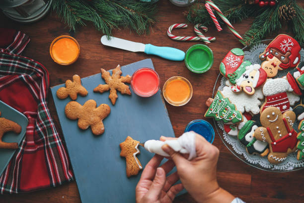 istock Decorating Gingerbread Christmas Cookies with Icing 1446068663