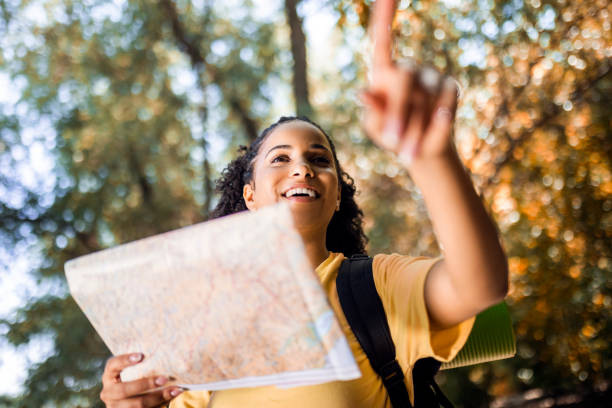 istock Young woman hiking pointing a way 1446069401