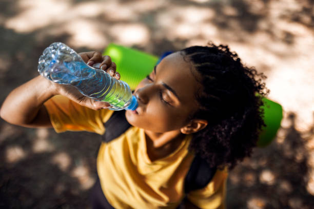 istock Young woman hiker taking a break drinking water in shade 1446069410