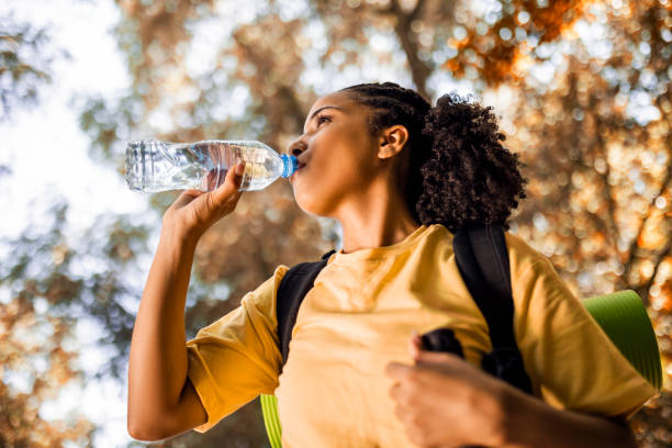 istock Young woman hiker taking a break hydrating 1446069429