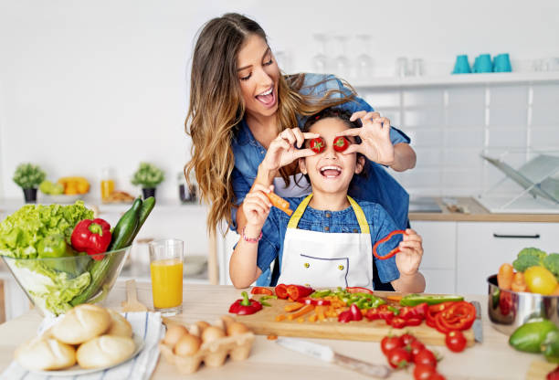 istock Mother and daughter cooking together in a kitchen 1446069688