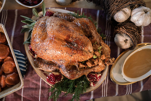 a black family gathers together to cook and eat a Thanksgiving meal.